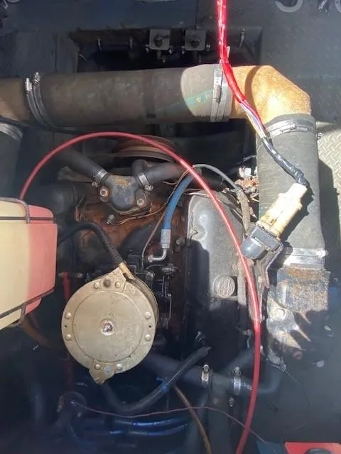 Slide: The Image of Engine compartment of a 1992 Regal 40 Commodore boat, showing various mechanical components and wiring. - 23