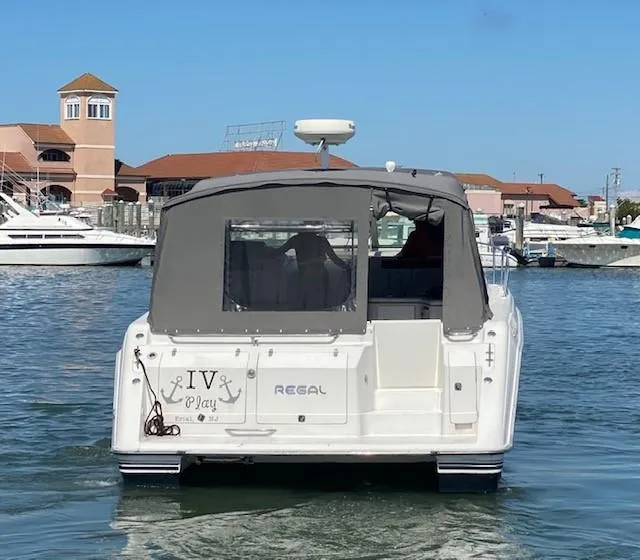 Slide: The Image of 1992 Regal 40 Commodore boat docked in marina, rear view with canopy. - 26