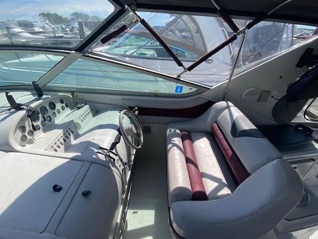 Slide: The Image of 1992 Regal 40 Commodore boat cockpit with steering wheel and seating, docked at marina. - 7
