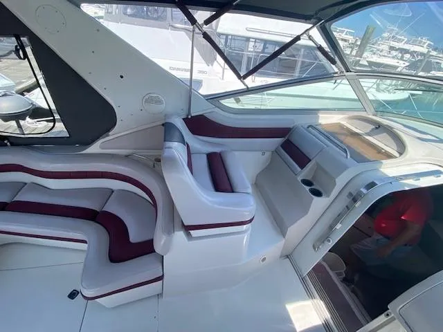 Slide: The Image of Interior of a 1992 Regal 40 Commodore yacht with white and maroon seating. - 8