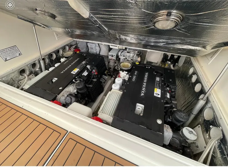 Slide: The Image of Engine compartment of a 2006 Carolina Classic 28 Express boat with Volvo Penta engines. - 24
