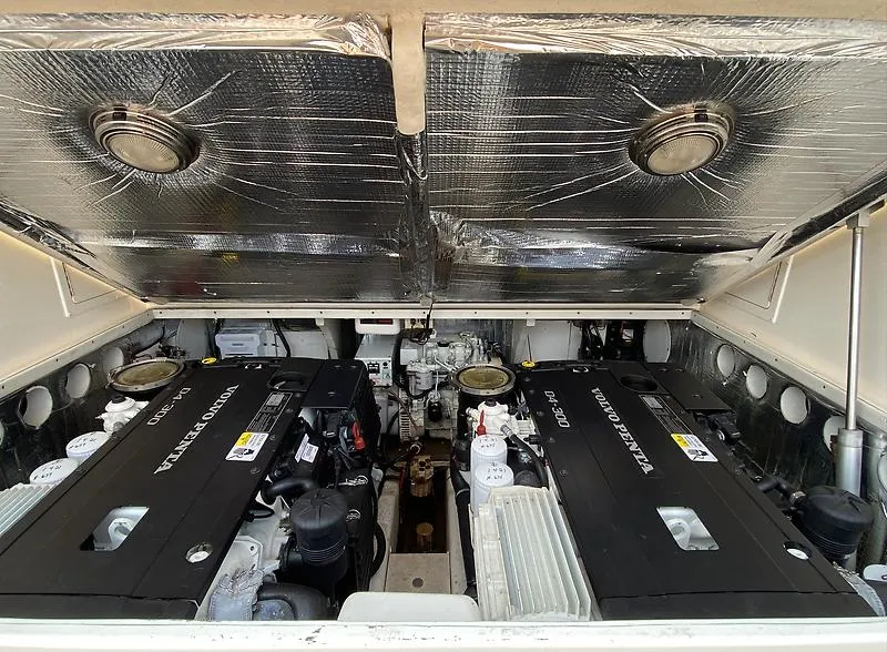 Slide: The Image of Engine compartment of a 2006 Carolina Classic 28 Express boat with Volvo Penta engines. - 26