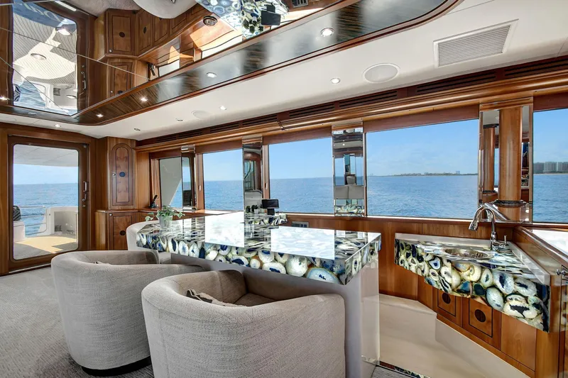 Slide: The Image of Luxurious 2005 Hatteras Semi-Displacement yacht interior with elegant seating and ocean view. - 10
