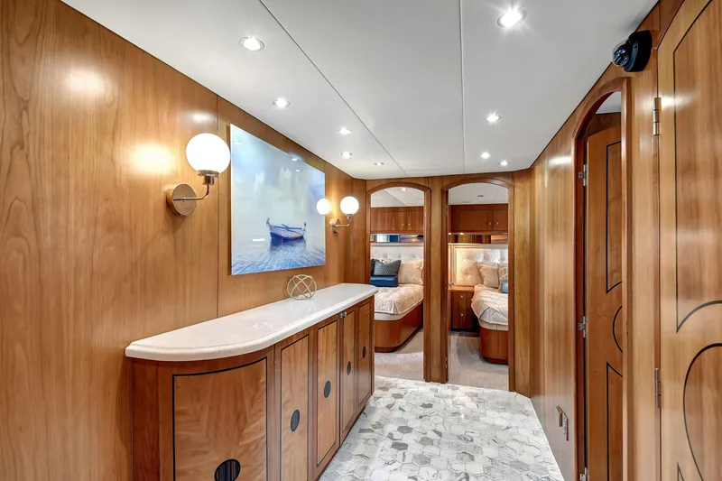 Slide: The Image of Luxurious 2005 Hatteras Semi-Displacement yacht interior with elegant wood paneling and modern lighting. - 20