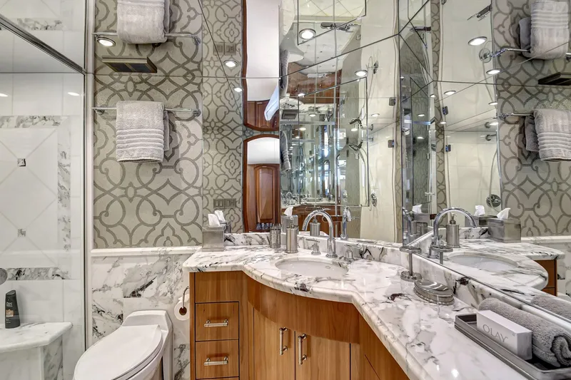 Slide: The Image of Luxurious 2005 Hatteras Semi-Displacement yacht bathroom with marble countertops and elegant design. - 26