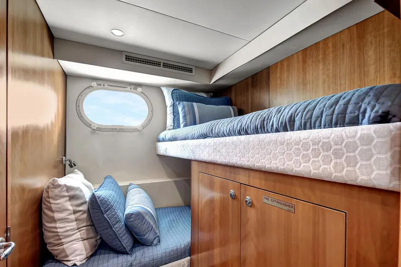 Slide: The Image of 2005 Hatteras Semi-Displacement yacht cabin with bunk beds and porthole window. - 35