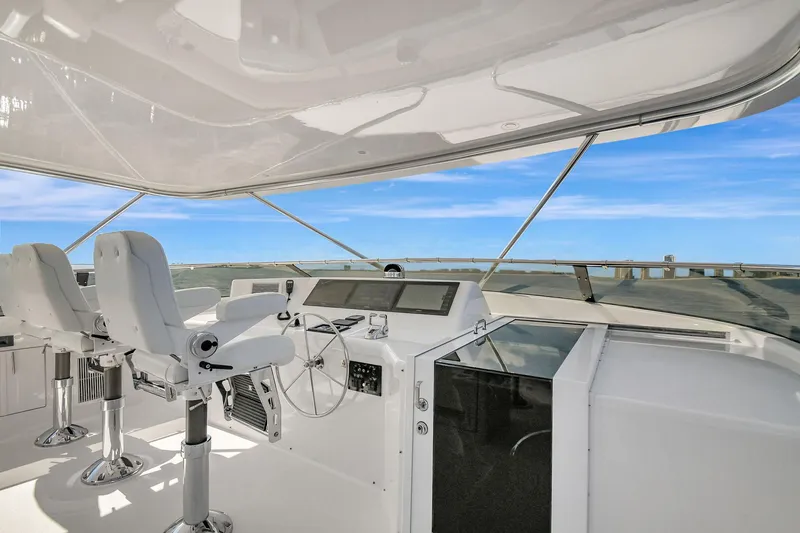 Slide: The Image of 2005 Hatteras Semi-Displacement yacht helm with modern controls and ocean view. - 39