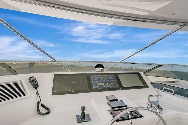 Slide: The Image of Helm of 2005 Hatteras Semi-Displacement yacht with modern controls and blue sky view. - 40