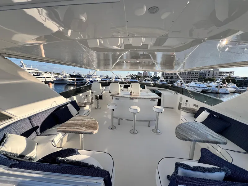 Slide: The Image of Luxurious 2005 Hatteras Semi-Displacement yacht interior with elegant seating and marina view. - 42