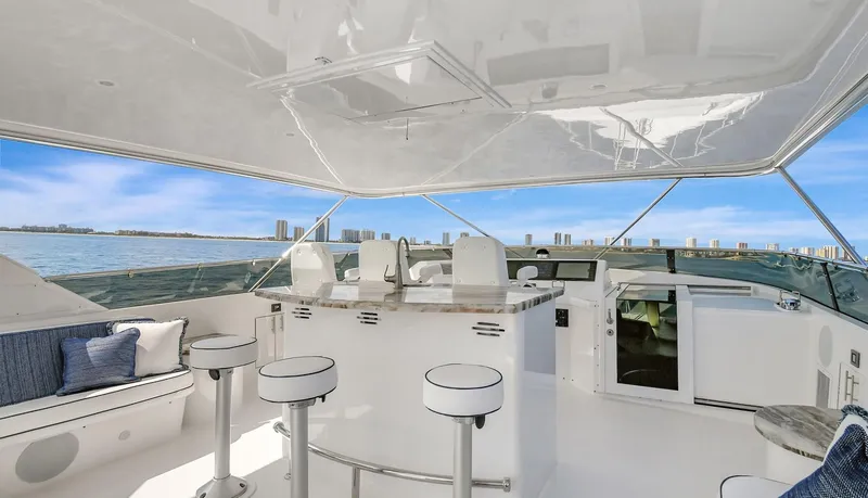 Slide: The Image of Luxury 2005 Hatteras Semi-Displacement yacht interior with bar stools and ocean view. - 45