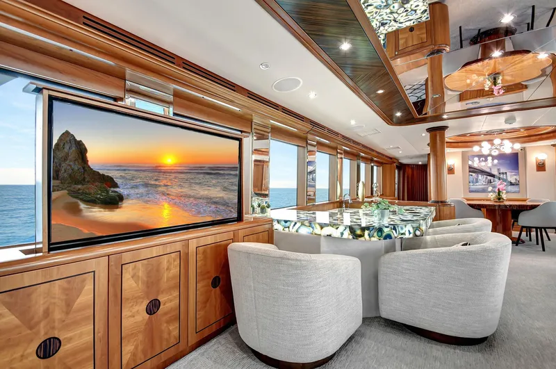 Slide: The Image of Luxurious 2005 Hatteras Semi-Displacement yacht interior with elegant seating and large screen. - 9