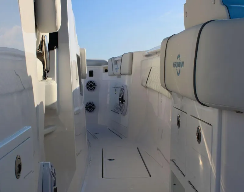 Slide: The Image of 2025 Fountain 38 SCX boat interior with white seating and built-in speakers. - 10