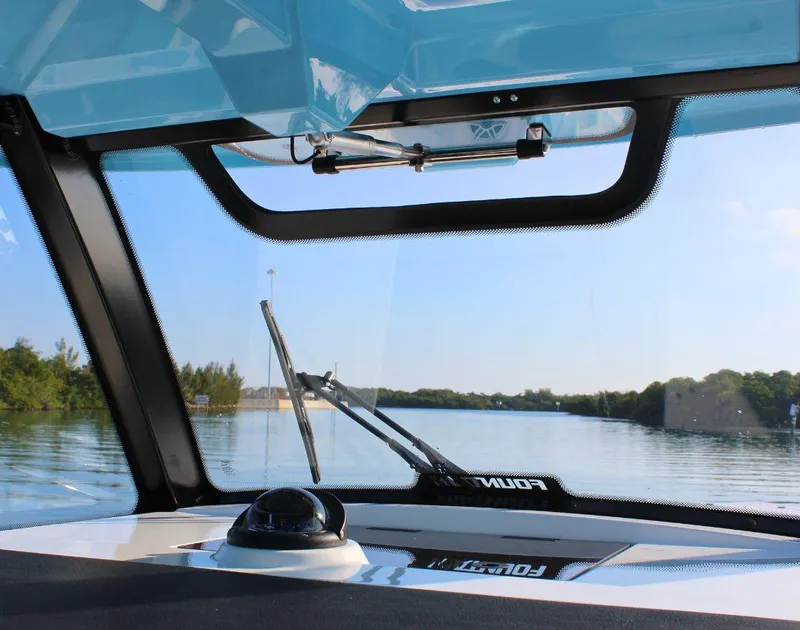 Slide: The Image of View from the 2025 Fountain 38 SCX boat cockpit, overlooking calm waters and clear skies. - 18
