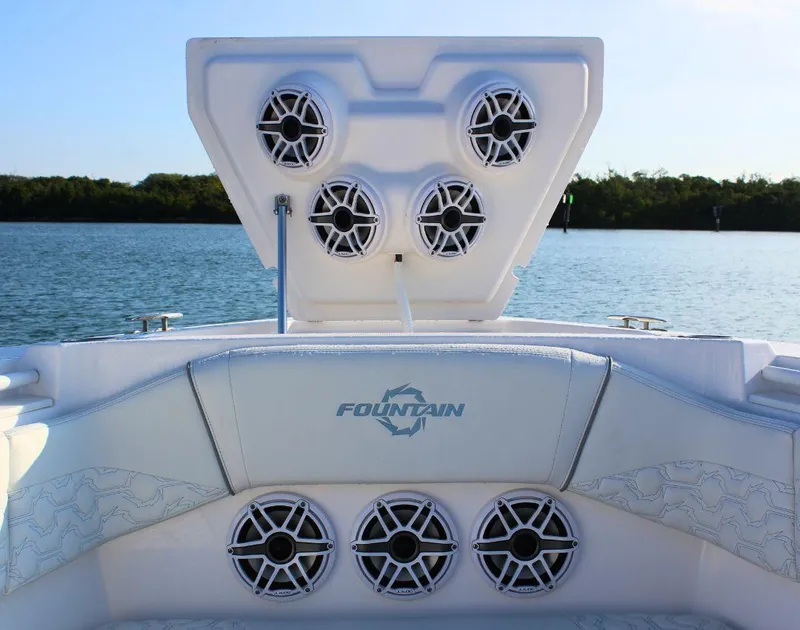 Slide: The Image of 2025 Fountain 38 SCX boat speakers on deck, scenic water backdrop. - 24