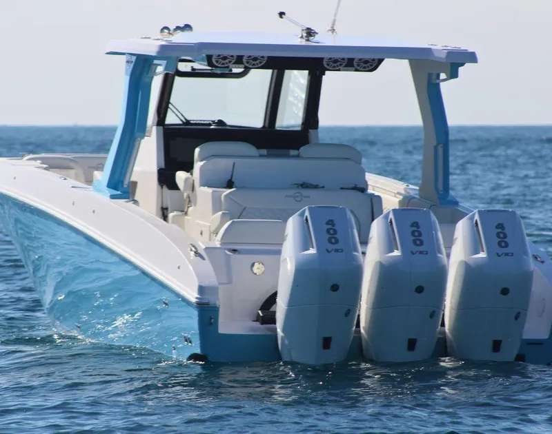 Slide: The Image of 2025 Fountain 38 SCX boat with triple 400 V10 engines on open water. - 3