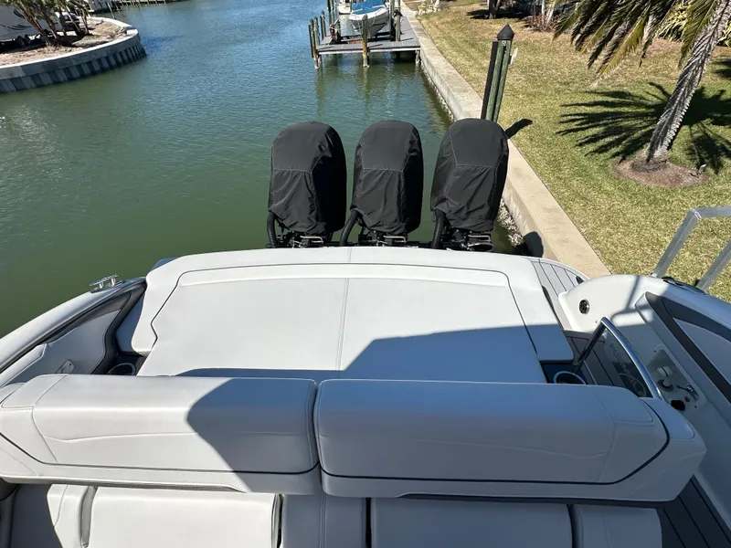Slide: The Image of 2020 Formula 350 Crossover Bowrider OB with covered outboard motors, docked by a canal. - 10