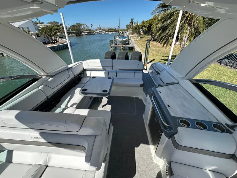 Slide: The Image of 2020 Formula 350 Crossover Bowrider OB, spacious seating, luxury interior, waterfront view. - 16