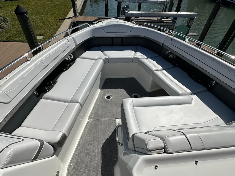 Slide: The Image of 2020 Formula 350 Crossover Bowrider OB with spacious seating in a marina setting. - 18