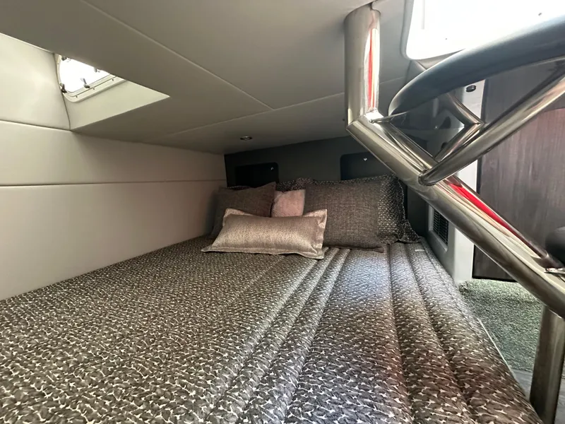 Slide: The Image of 2020 Formula 350 Crossover Bowrider OB cabin interior with cozy bedding and modern design. - 25