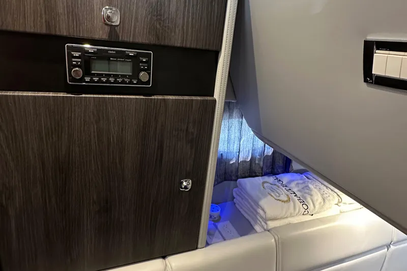 Slide: The Image of Interior of 2020 Formula 350 Crossover Bowrider OB with wood paneling and folded towels. - 28