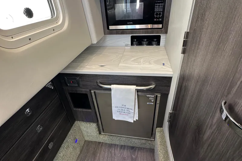 Slide: The Image of 2020 Formula 350 Crossover Bowrider OB interior kitchenette with microwave and compact fridge. - 30