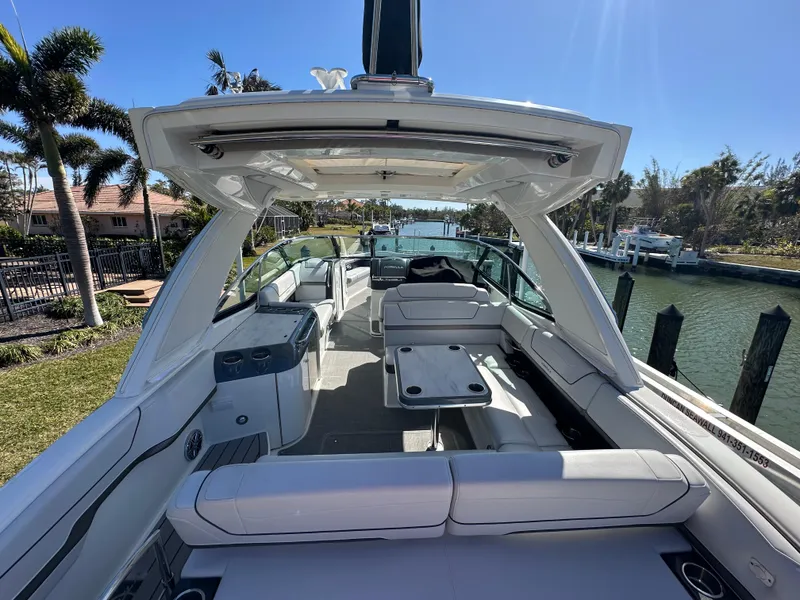 Slide: The Image of 2020 Formula 350 Crossover Bowrider OB, luxurious interior, docked by a scenic canal. - 9