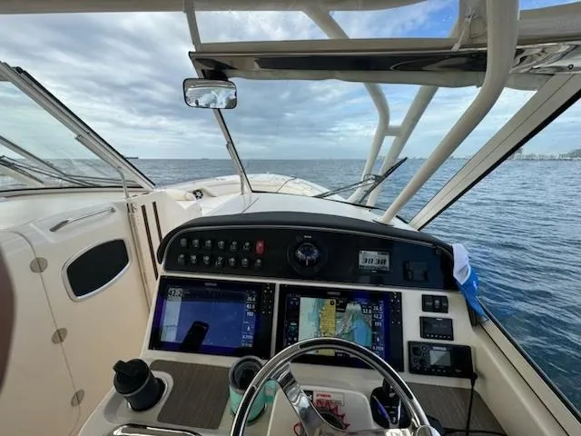 Slide: The Image of 2024 Grady-White Freedom 335 cruising on open water, view from the deck. - 11