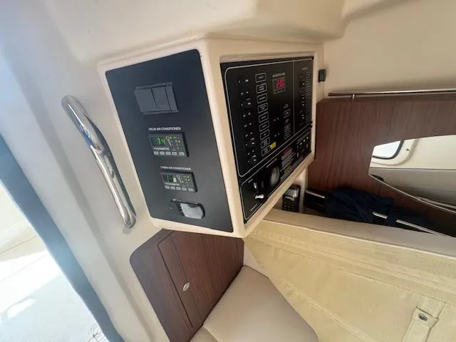 Slide: The Image of 2024 Grady-White Freedom 335 boat dashboard at night with illuminated controls and screens. - 13