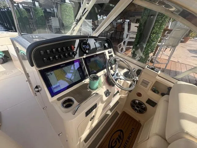 Slide: The Image of 2024 Grady-White Freedom 335 cabin interior with control panel and seating. - 14