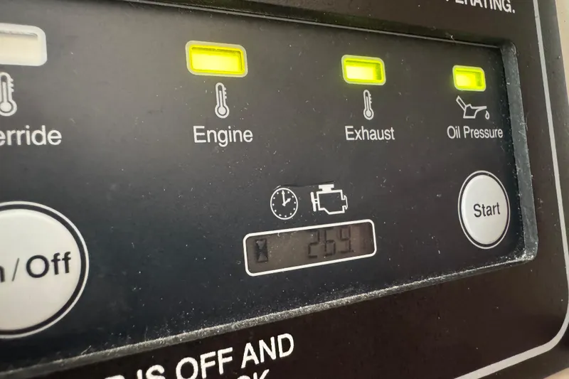 Slide: The Image of 2024 Grady-White Freedom 335 boat interior with seating, sink, and marina view. - 18