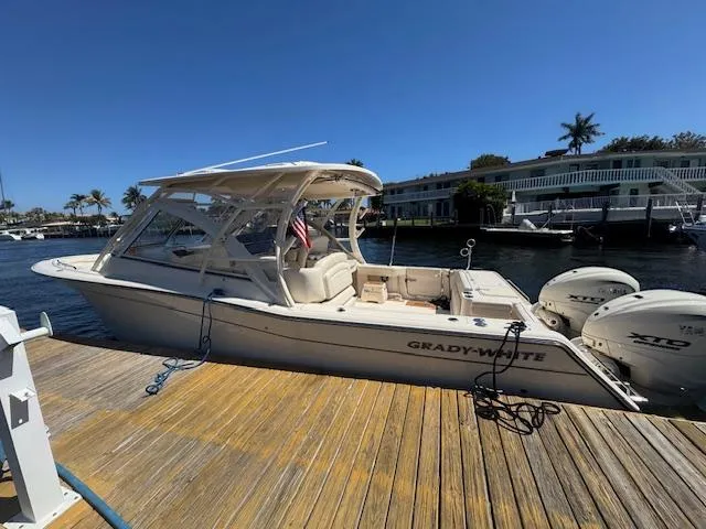 Slide: The Image of 2024 Grady-White Freedom 335 boat docked on a sunny day. - 2
