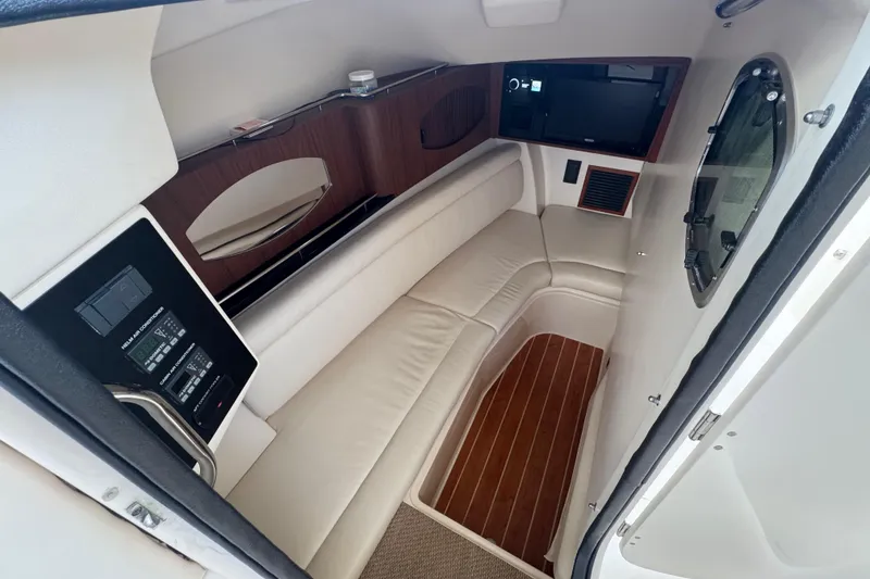 Slide: The Image of 2024 Grady-White Freedom 335 boat with open storage compartments and twin Yamaha engines. - 24