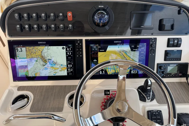 Slide: The Image of Simrad radio and speaker on 2024 Grady-White Freedom 335 boat interior. - 28