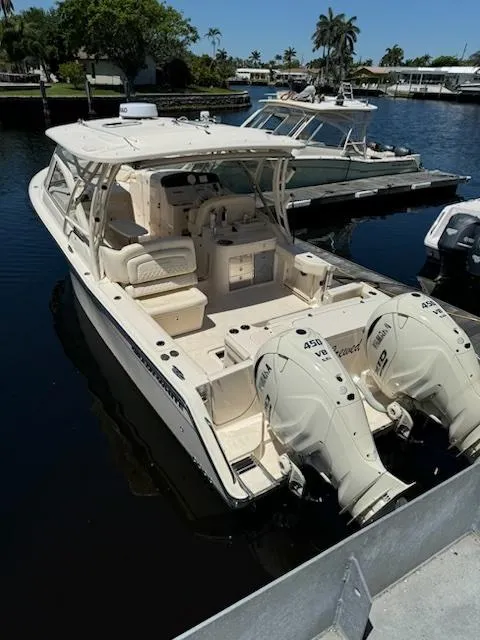 Slide: The Image of 2024 Grady-White Freedom 335 boat docked at marina with people onboard. - 3