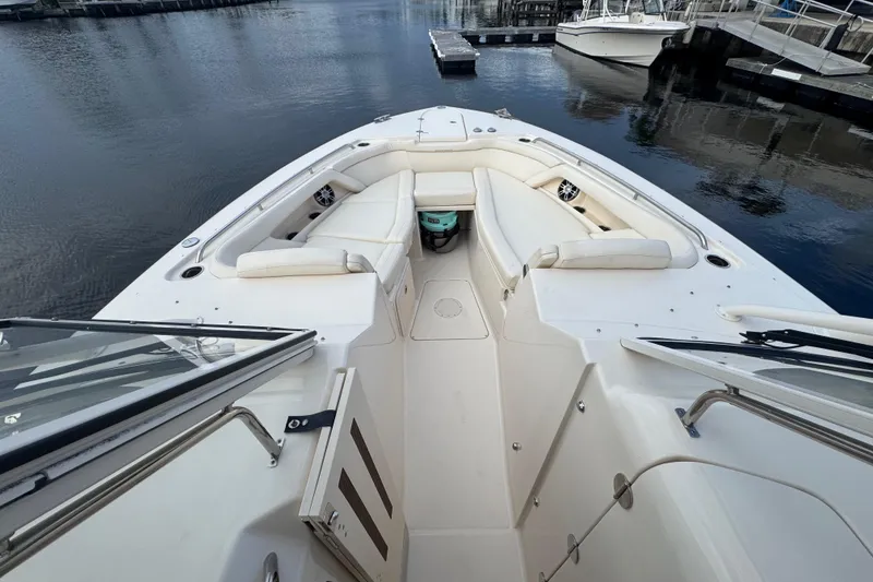 Slide: The Image of 2024 Grady-White Freedom 335 dashboard with dual Simrad displays and steering wheel. - 31