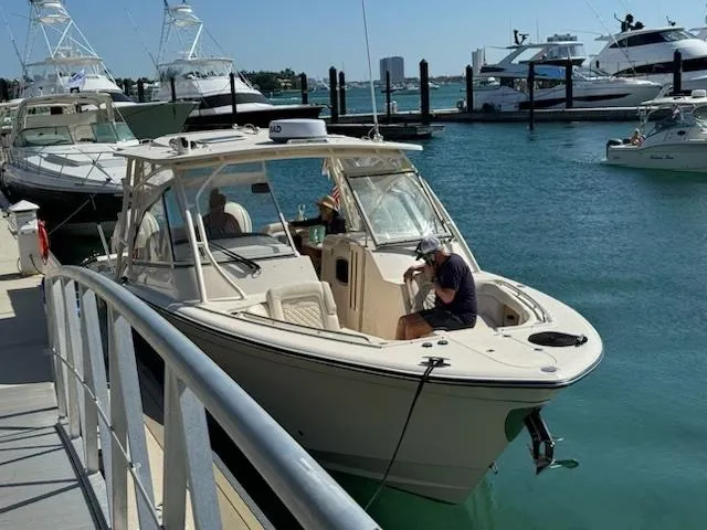 Slide: The Image of 2024 Grady-White Freedom 335 boat docked on a sunny day. - 4
