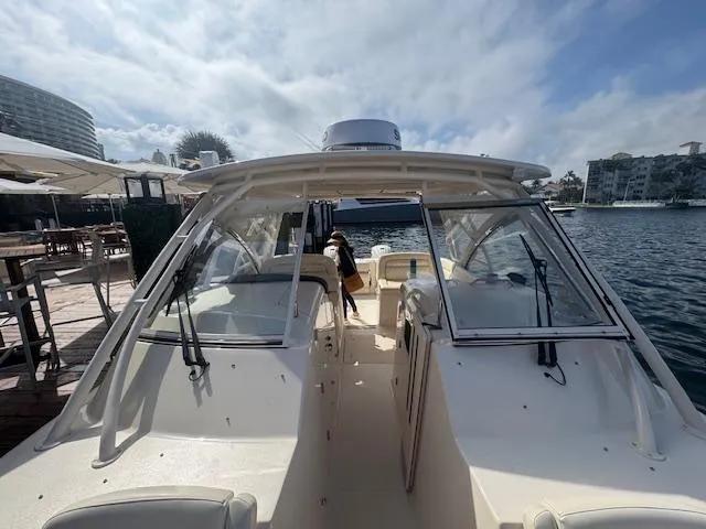 Slide: The Image of 2024 Grady-White Freedom 335 boat docked on a sunny day. - 5