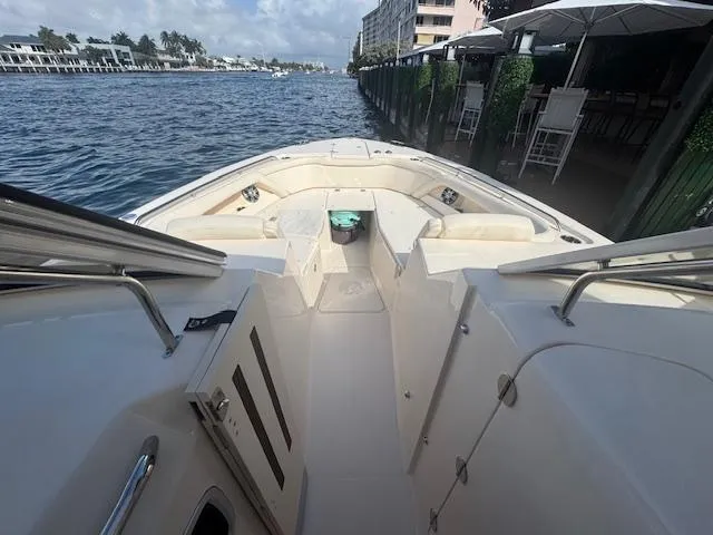 Slide: The Image of 2024 Grady-White Freedom 335 boat interior with seating, docked by the water. - 7