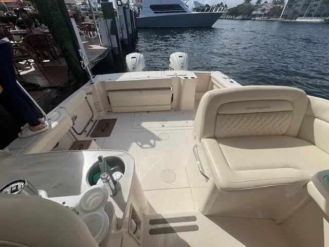 Slide: The Image of 2024 Grady-White Freedom 335 boat docked under a cloudy sky. - 8