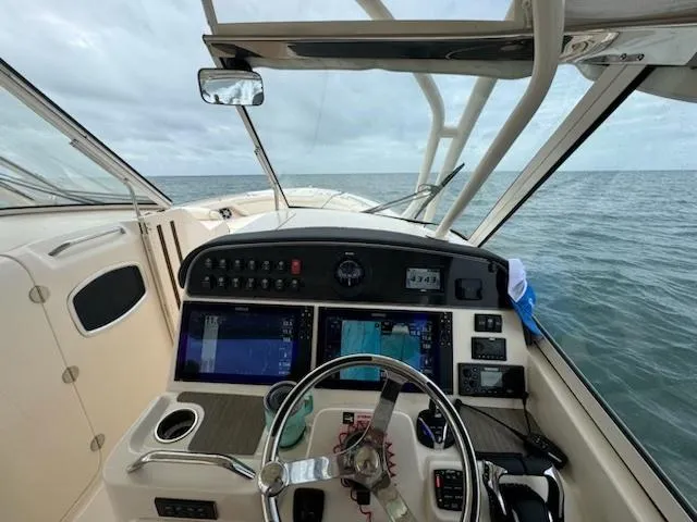 Slide: The Image of 2024 Grady-White Freedom 335 boat with spacious, luxurious seating on calm water. - 9