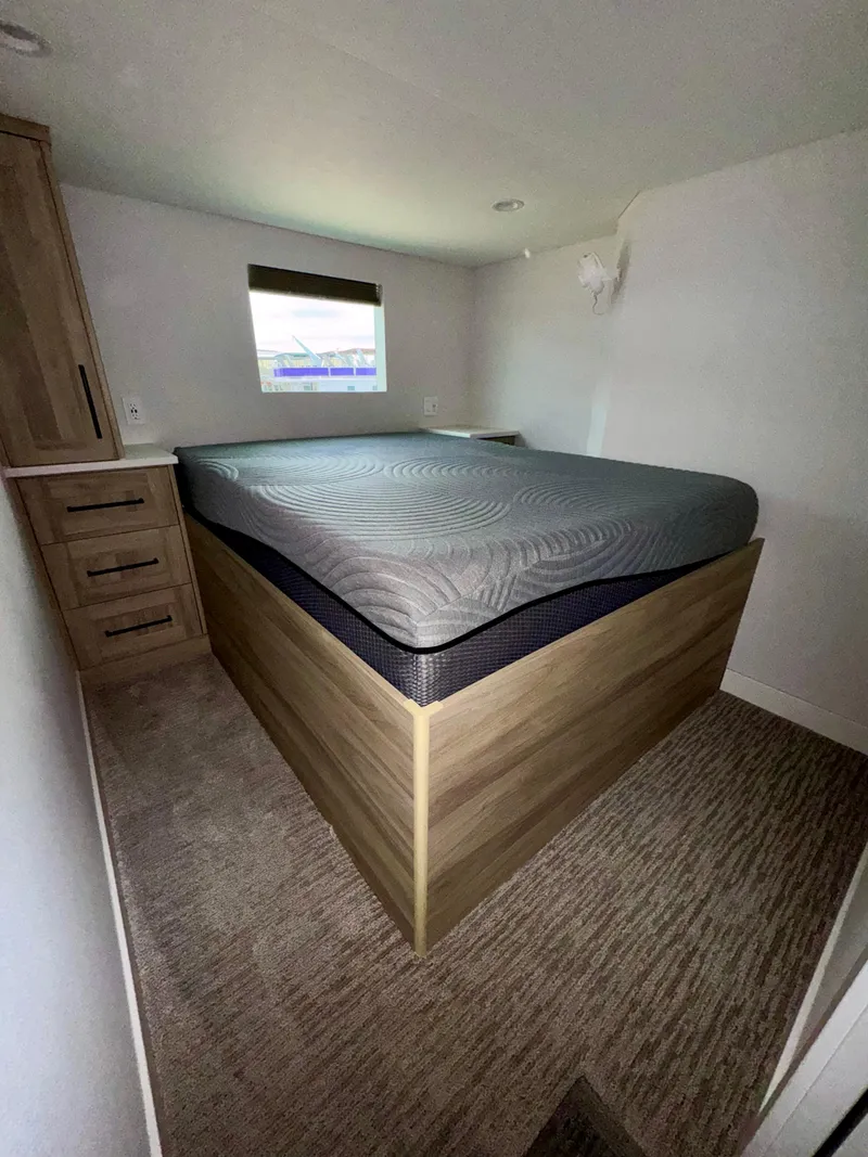 Slide: The Image of Compact bedroom in 2024 Adonia Cosmos Trip #11 RV with elevated bed and storage. - 10