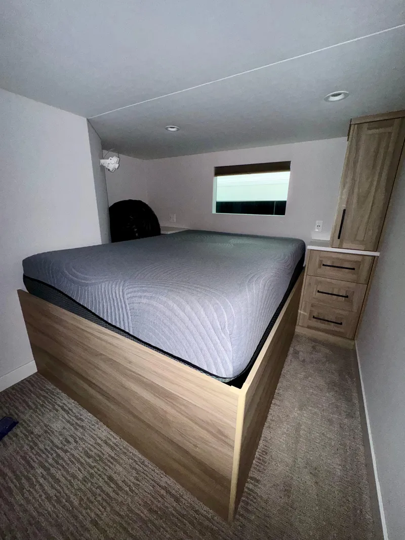 Slide: The Image of Compact bedroom in Adonia Cosmos Trip #11 RV, featuring a cozy bed and storage, 2024 model. - 12