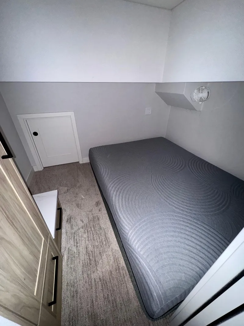 Slide: The Image of Compact bedroom in Adonia Cosmos Trip #11, 2024 model, featuring a minimalist design and cozy bed. - 14