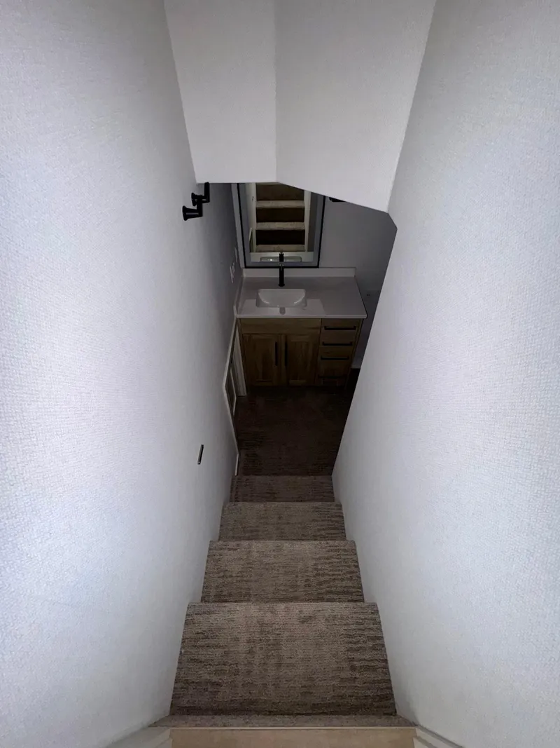 Slide: The Image of Narrow staircase leading to a small bathroom with a sink, Adonia Cosmos Trip #11, 2024. - 16