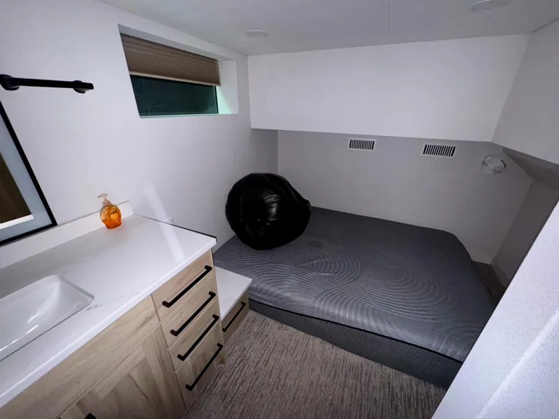 Slide: The Image of Compact bedroom in Adonia Cosmos Trip #11, 2024 model, featuring a bed and modern sink area. - 17