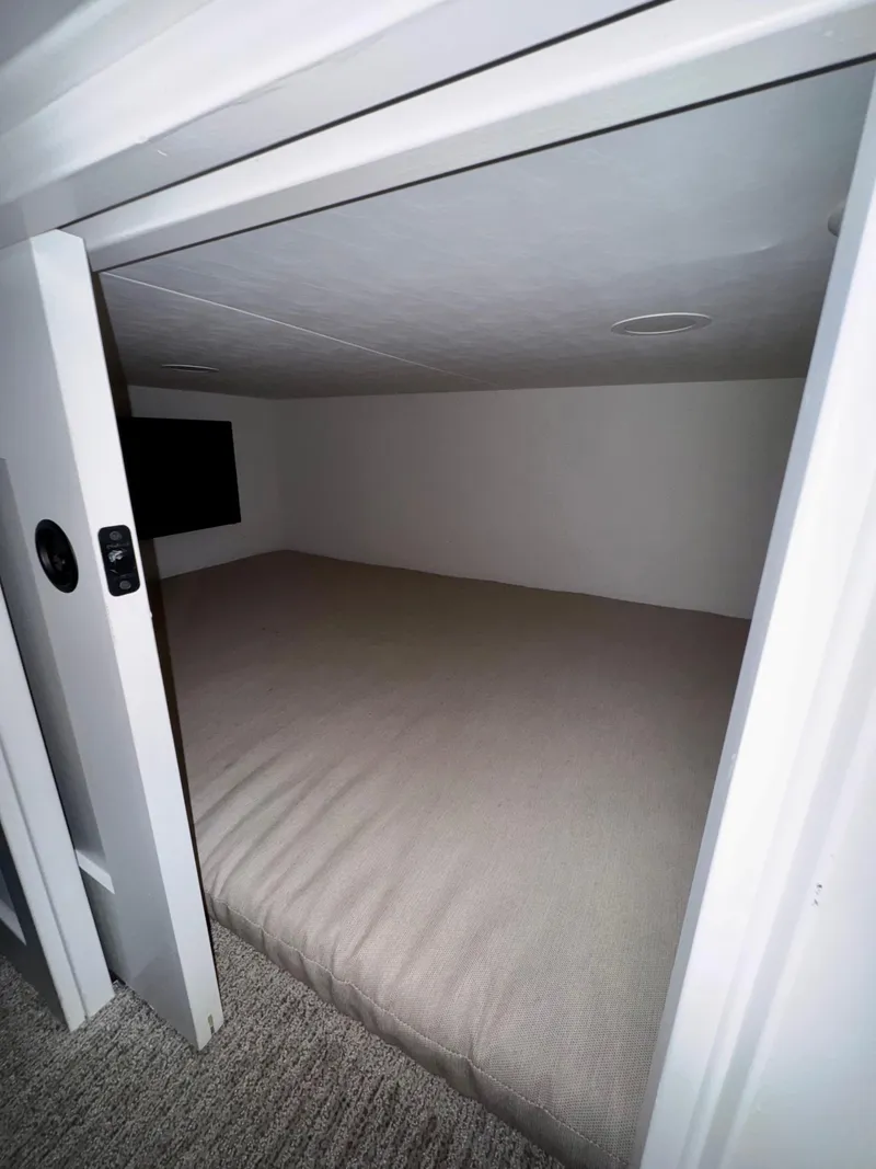 Slide: The Image of Compact sleeping area in Adonia Cosmos Trip #11, 2024 model, featuring a cozy bed and minimalist design. - 18