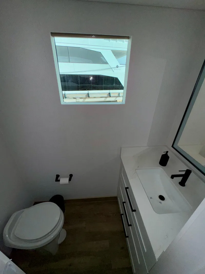 Slide: The Image of Compact bathroom with modern fixtures in Adonia Cosmos Trip #11, 2024 model. - 19