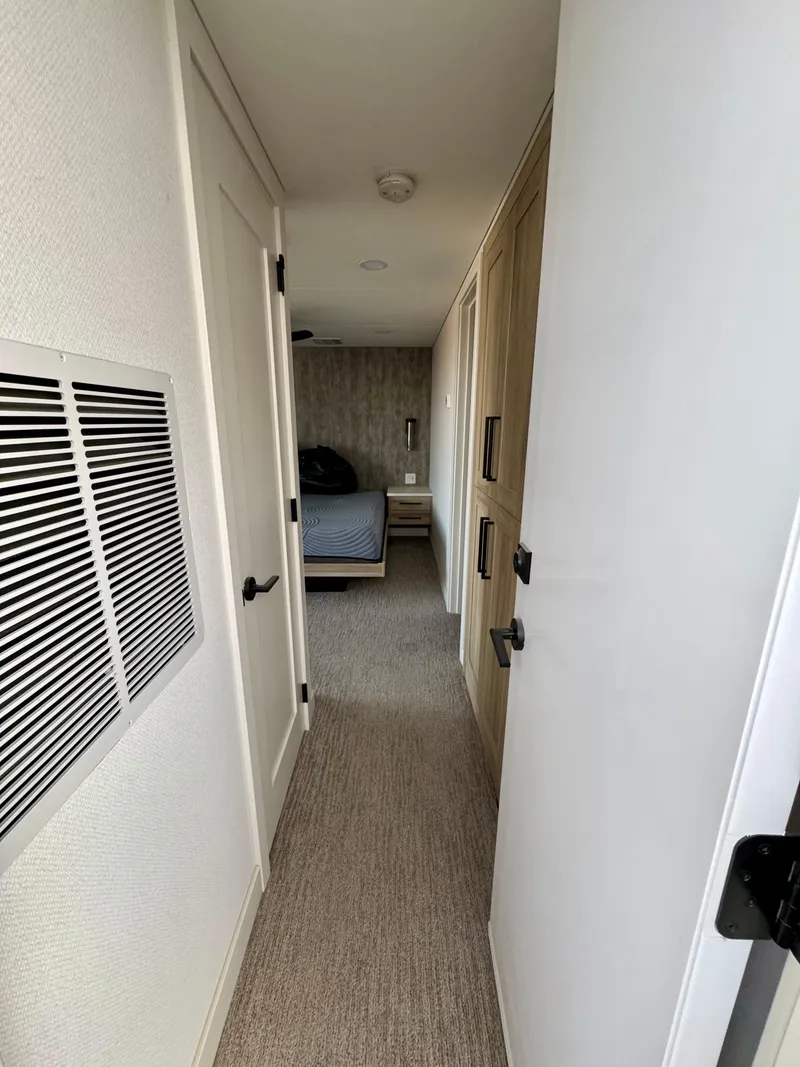 Slide: The Image of Narrow hallway in Adonia Cosmos Trip #11, 2024 model, leading to a bedroom. - 22