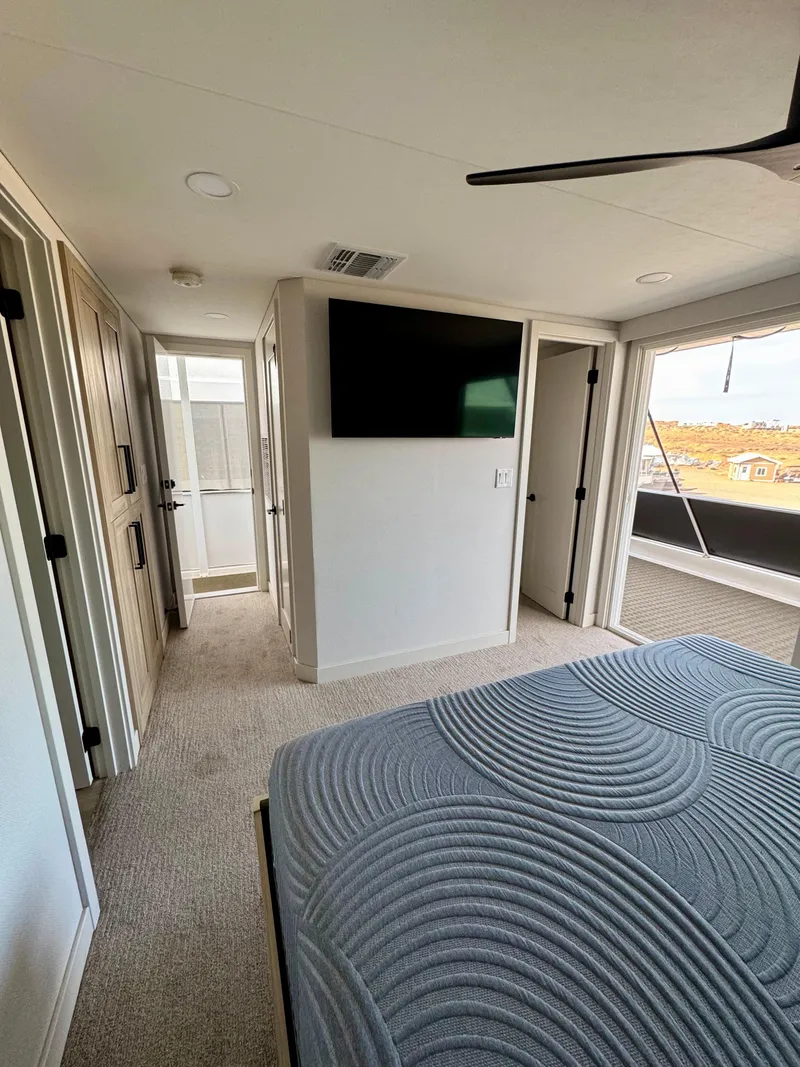 Slide: The Image of Modern bedroom interior in Adonia Cosmos Trip #11, 2024 model, featuring a TV and stylish decor. - 25