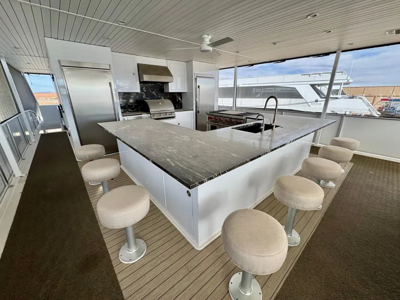 Slide: The Image of Modern yacht kitchen with marble countertop and bar stools, Adonia Cosmos Trip #11, 2024 model. - 29